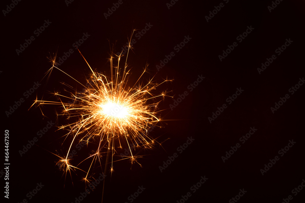 photo in a close-up shot, a golden sparkler of celebration during the New Year, and festivity of Christmas