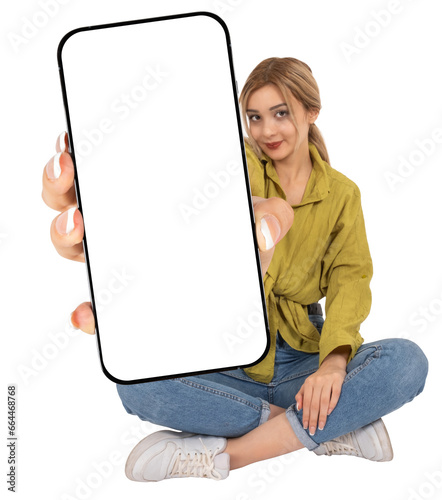 Phone with blank screen, full length body view sitting woman hold mobile phone with blank screen. Showing big smartphone mock up to camera. Banner advertising design template idea. Transparent png.