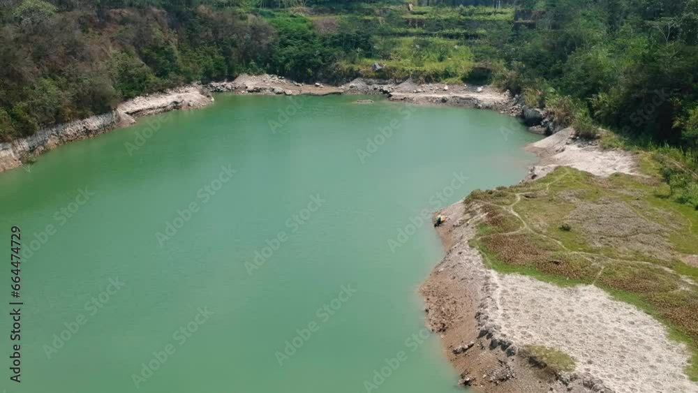 The aerial view resembles a lake that appears during the dry season. drone footage of a river that is not flowing and decreases in volume until it finally becomes a pool of water resembling a lake The aerial view resembles a lake that appears during the dry season. drone footage of a river that is not flowing and decreases in volume until it finally becomes a pool of water resembling a lake