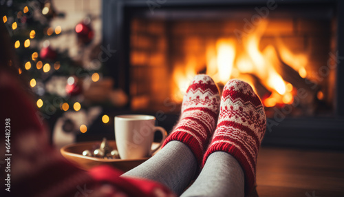 Fotografia On a cold winter night, there's nothing quite as relaxing as warming your feet by the fireplace in cozy socks, surrounded by the festive atmosphere of the Christmas season