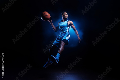 Basketball superstar leaps through the air, isolated against a black studio background, surrounded by dramatic lighting and smoke effects. Generative AI. © Surachetsh
