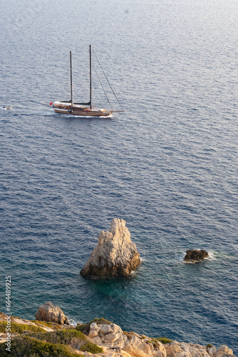 Sailboat crossing the Mediterranean Sea next to the cliffs of Datça, Türkiye