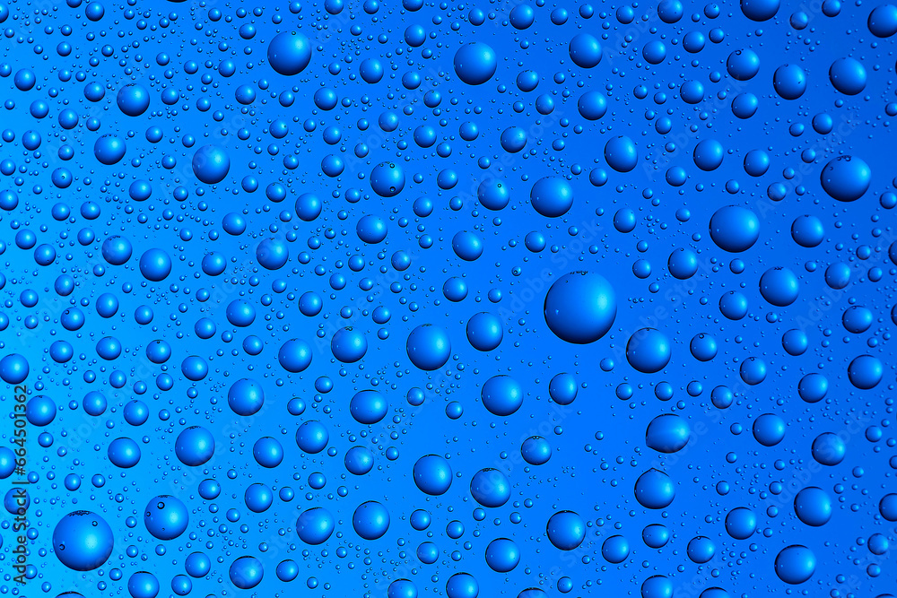 Bubbles and water drops in selective focus on glass, blue background. Bubbles and water drops in selective focus on glass, blue background.