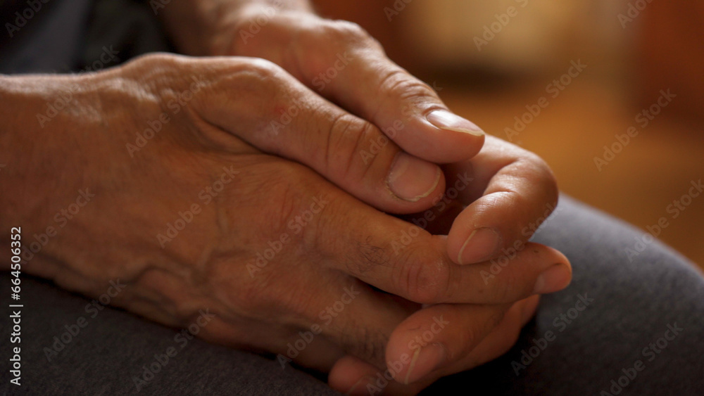 The older man's hands are on his knees, waiting. The older man's hands are on his knees, waiting.
