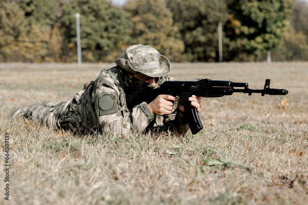 Soldiers in formation. Soldiers with a machine gun in military uniform. Special forces with weapons take part in a military maneuver. War, army, equipment and the concept of people. Camouflage. Traini