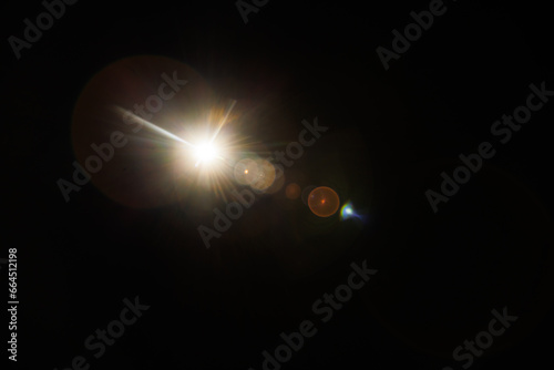 Easy to add lens flare effects for overlay designs or screen blending mode to make high-quality images. Abstract sun burst, digital flare, iridescent glare over black background.