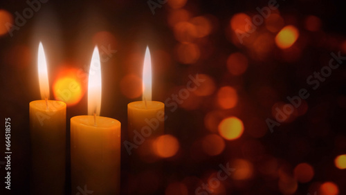 Candles in the Christmas Lights features three holiday candles flickering in an atmosphere of floating diffused lights, Not A.I. generated.