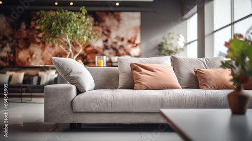 Modern sofa in focus and blurred living room design at background.