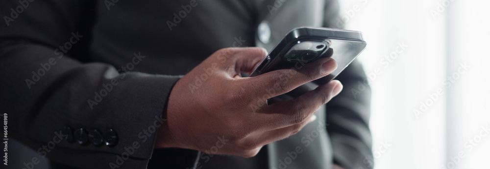 Landscape image, businessman hands use smartphone app, communicate online, surf the Internet, banner for website header design with copy area for text.
Landscape image, businessman hands use smartphone app, communicate online, surf the Internet, banner for website header design with copy area for text.