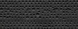 Seamless perforated black leather background texture. Tileable trendy elegant dark grey leatherette with pierced holes. Luxury steering wheel or auto seat upholstery material pattern