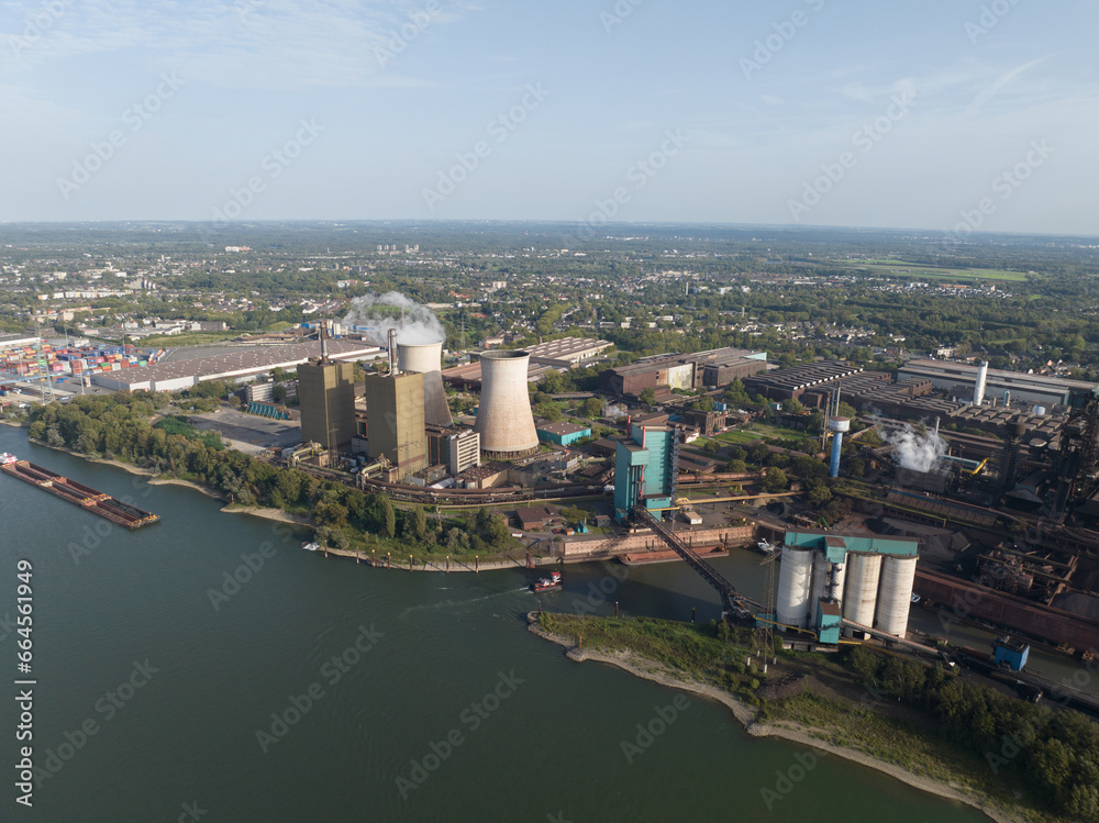 Aerial drone view of an electricity genration plant, cooling towers, some stacks.