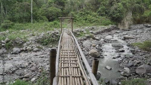 wooden bridge over a lively river in the rain forest at Tierradentro national archeological park in Colombia. photo