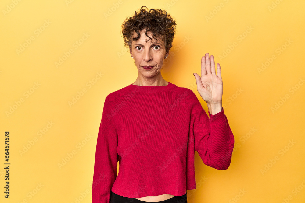Mid-aged caucasian woman on vibrant yellow smiling cheerful showing number five with fingers. Mid-aged caucasian woman on vibrant yellow smiling cheerful showing number five with fingers.