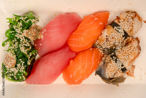 Sushi with salmon, eel, tuna, hiyashi wakame, sesame isolated. photo