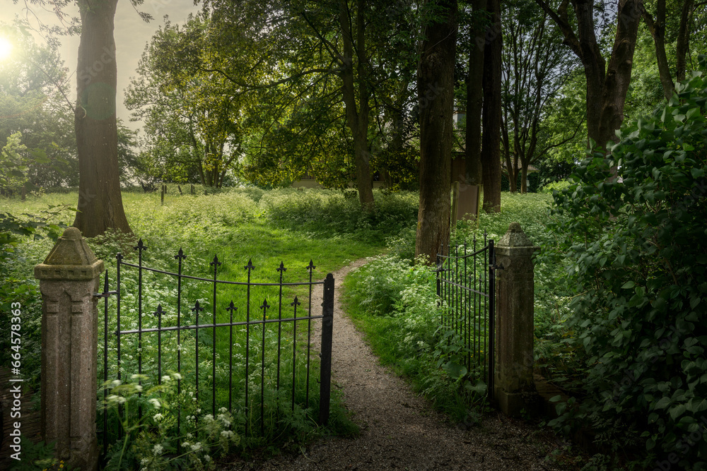 Wittewierum, The Netherlands, 05-25-2018.Surrounding the church is a graveyard that is deliberately kept in a somewhat rough state and has a large number of gravestones from the 18th to the early 20th Wittewierum, The Netherlands, 05-25-2018.Surrounding the church is a graveyard that is deliberately kept in a somewhat rough state and has a large number of gravestones from the 18th to the early 20th