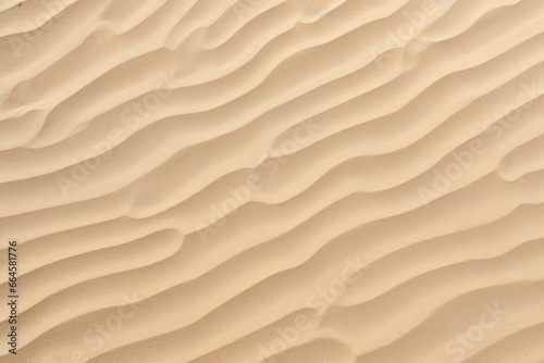 Closeup of sand pattern of a beach in the summer. © MstHafija