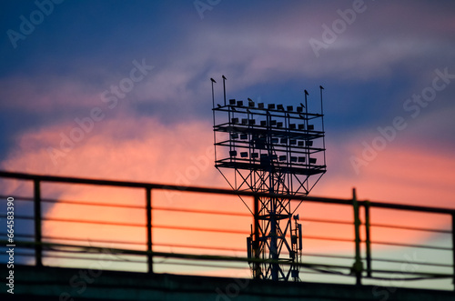 Sport stadium light tower on sunset