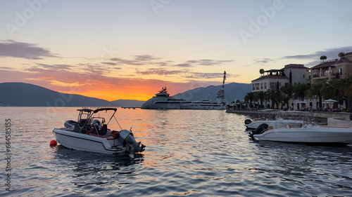 Boat at sunset.  Boats, yachts at Adriatic sea bay at sunset. Porto Montenegro, Tivat