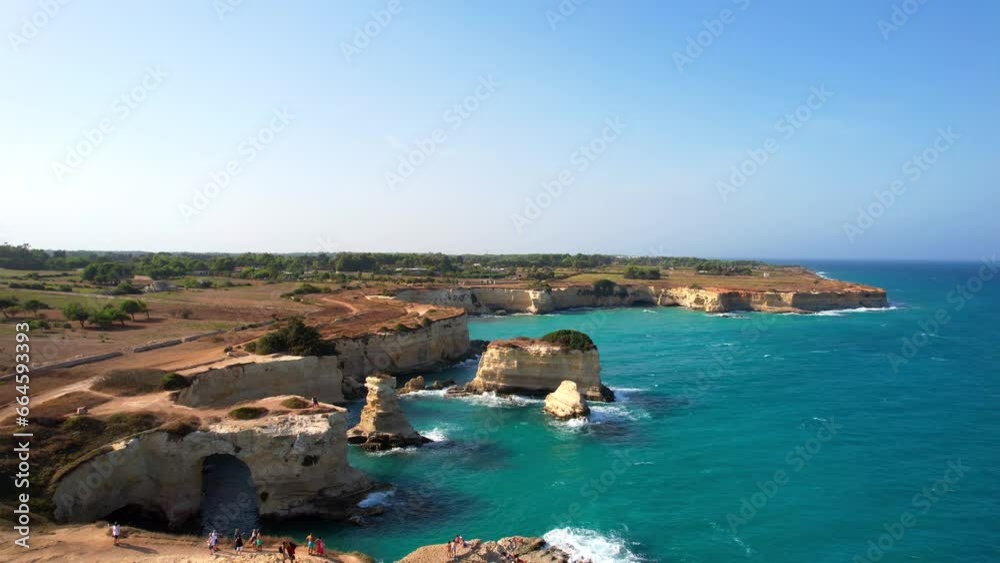 Torre Sant'Andrea - Aerial shot backwards towards the sea with a view of the layered rock formations