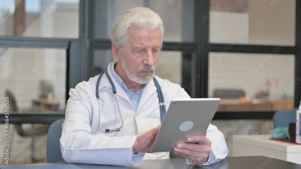 Senior Doctor Using Digital Tablet for Work Senior Doctor Using Digital Tablet for Work