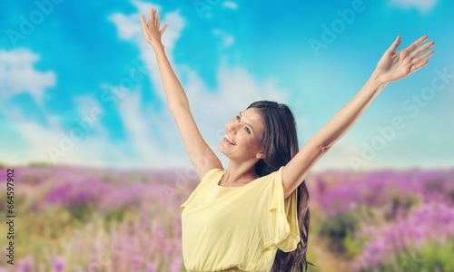Young happy woman breathing fresh air on street