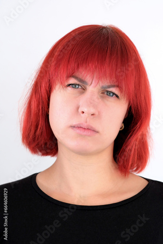 A young attractive woman with a short orange hairstyle