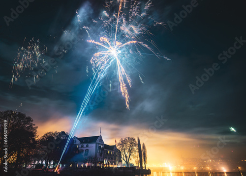 New Year's Eve midnight Steigenberger Hotel firework photographed from the boardwalk next to the Steigenberger Peninsula. Constance (Konstanz), Lake Constance (Bodensee), Baden-Württemberg, Germany. photo