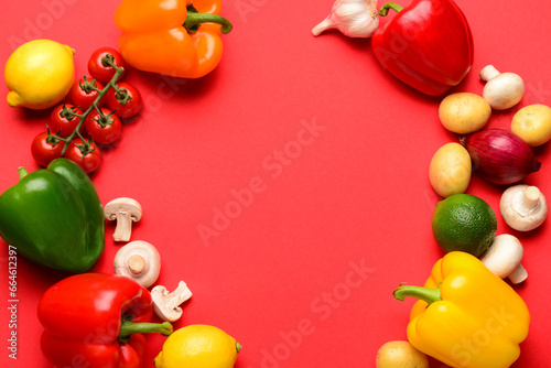 Frame made of fresh vegetables and fruits with mushrooms on red background