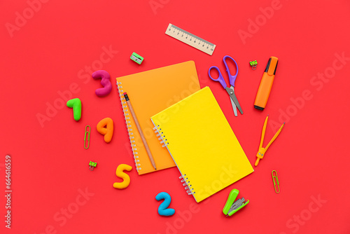 Composition with different stationery and numbers on red background