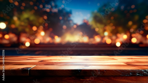 Wooden table with blurry background of trees and lights in the distance.