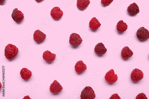 Fresh ripe raspberries on pink background