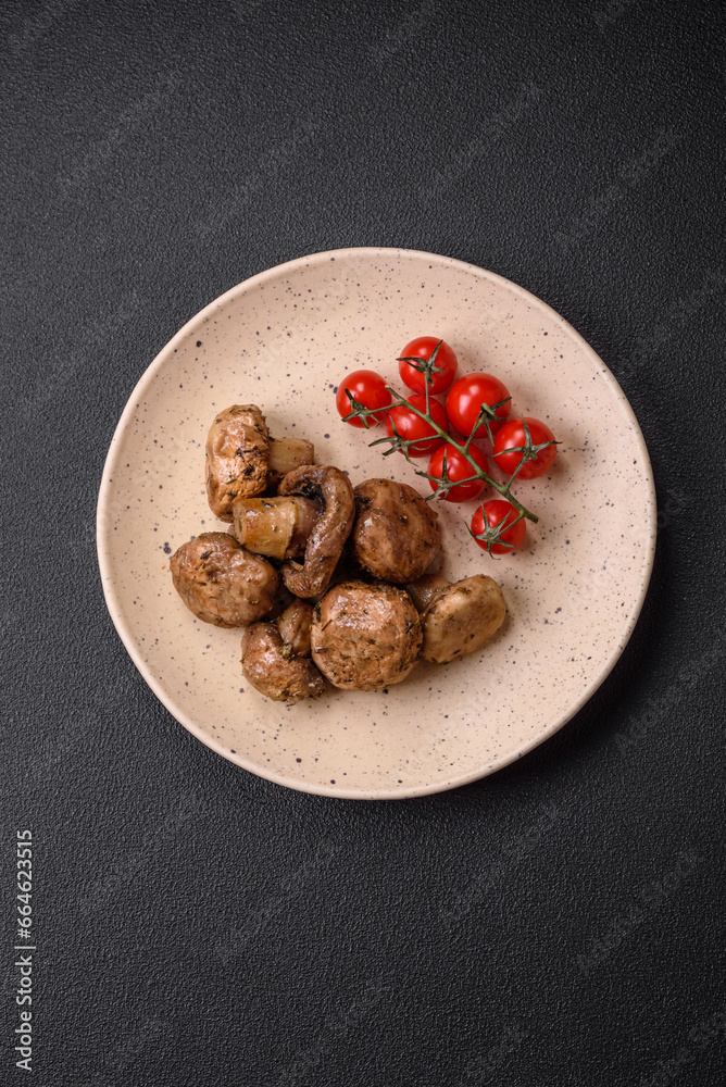 Fototapeta premium Delicious juicy whole champignons baked on the grill with salt and spices