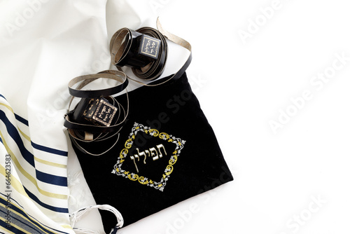 A photograph of ritual Jewish objects including prayer vestments with a hebrew inscription reading: On 1 object the symbols read: 