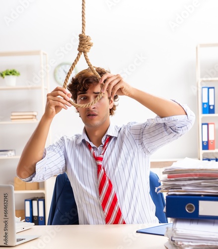 Fototapeta Desperate businessman thinking of committing suicide hanging