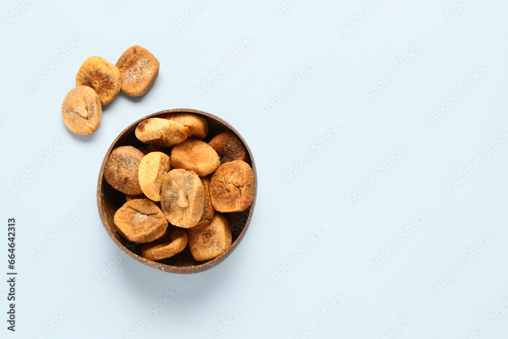 Bowl with sweet dried figs on blue background Bowl with sweet dried figs on blue background