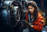 A female aircraft technician repairing the engine