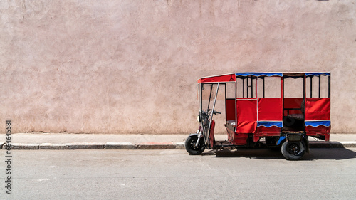 Tok tok vehicle parked in the old city of Marrakesh, Morocco. These tricycle vehicles are used mostly for tourism and public transportation purposes