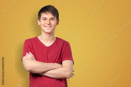 Young happy man standing over color background