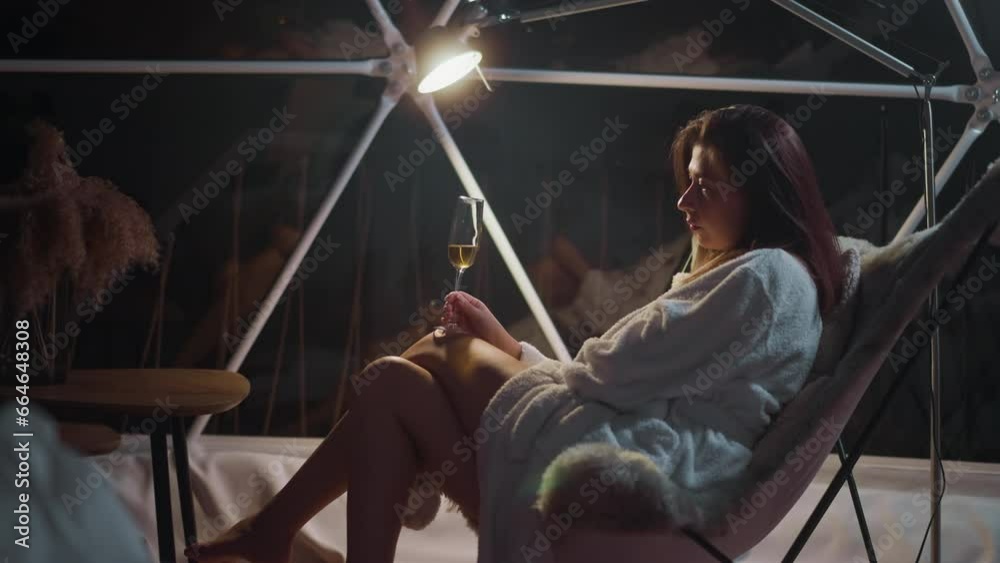 Exhausted lady sits in armchair with wineglass in hands suffering from loneliness on vacation. Rumination and absorption of individual by negative thoughts Exhausted lady sits in armchair with wineglass in hands suffering from loneliness on vacation. Rumination and absorption of individual by negative thoughts