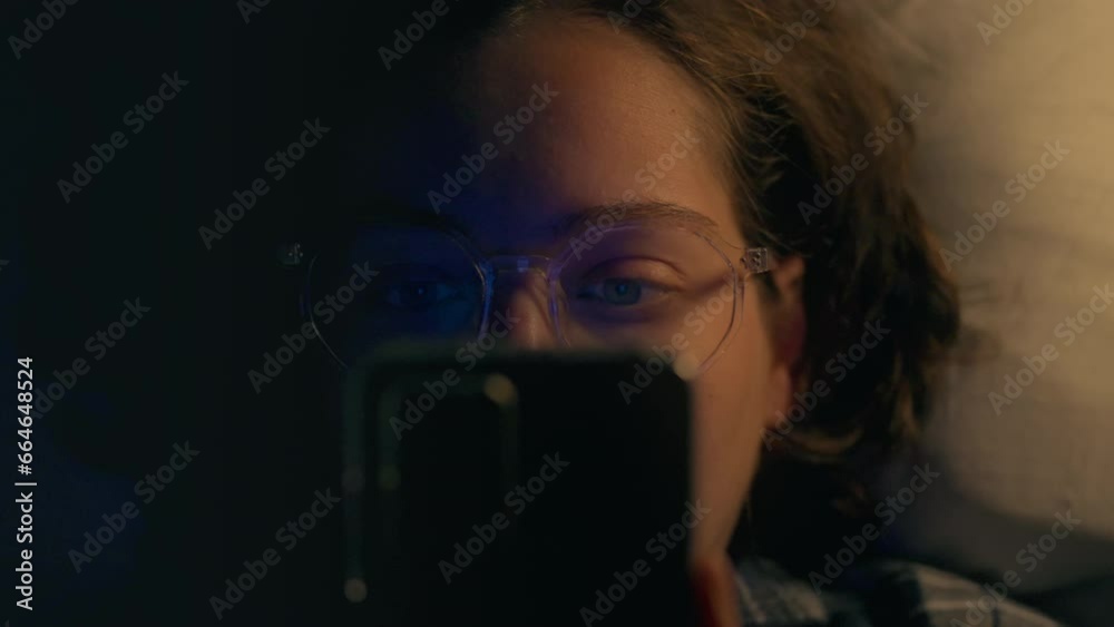 Night. Mature woman in loungewear confidently addicted to social networks in bedroom for sleep. Camera movement news follower uses mobile phone in the process of studying, stress Night. Mature woman in loungewear confidently addicted to social networks in bedroom for sleep. Camera movement news follower uses mobile phone in the process of studying, stress