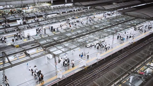 Crowd of people wait and board arriving train at subway station at night. Japanese commuter transportation lifestyle, Japan rail transport system, Asia travel tourism, Asian city life concept