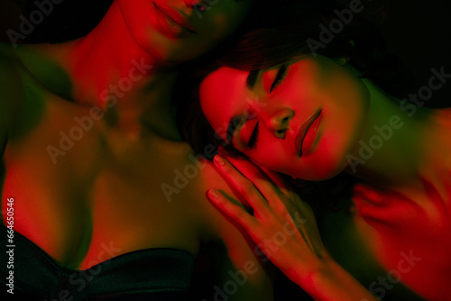 Photo of adorable stunning ladies nude shoulders smiling sleeping isolated dark color background