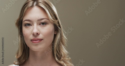 Portrait of caucasian woman with blond hair, copy space, slow motion