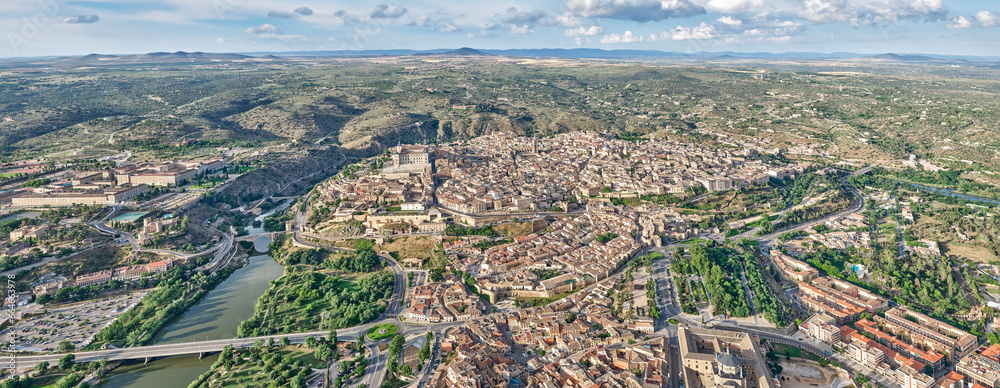 Panoramic aerial image of the north face of the old town of Toledo with the Mountains of Toledo in the background with soft light in the morning