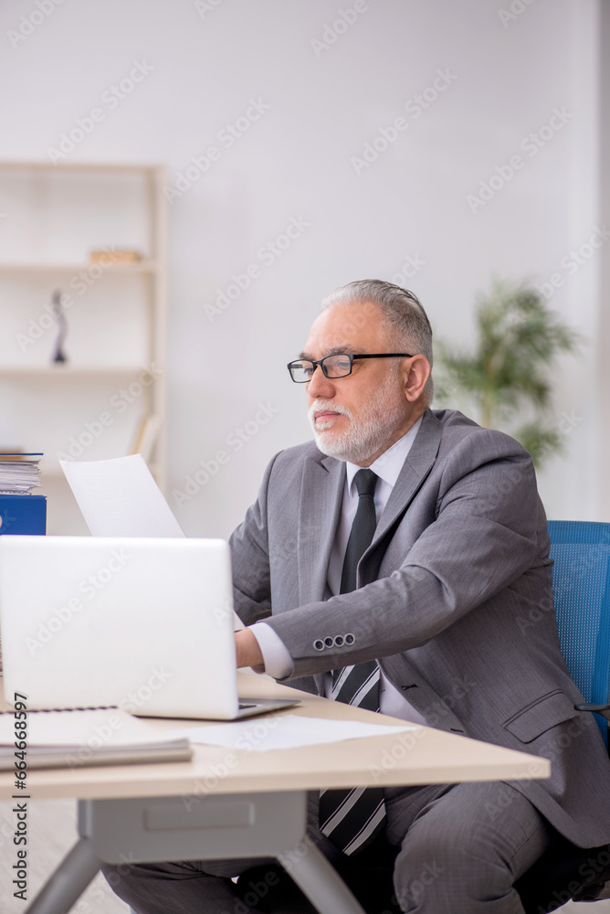 Old male employee and too much work in the office Old male employee and too much work in the office