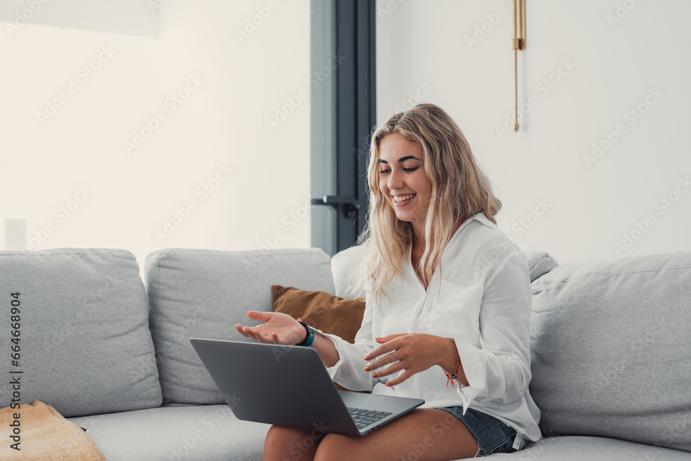 Portrait of young beautiful blonde girl talking with colleagues studying online in class room videocall learning. Working woman in a video conference.. Portrait of young beautiful blonde girl talking with colleagues studying online in class room videocall learning. Working woman in a video conference..