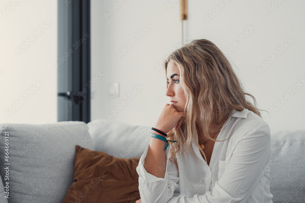 Positive serious millennial model girl home female head shot portrait. Beautiful young adult Caucasian woman looking at camera, posing in apartment. Front profile picture
