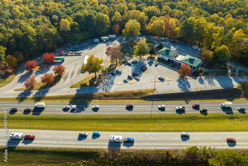 Quadro em tela Top view of large rest area near busy multilane american freeway with fast moving cars and trucks