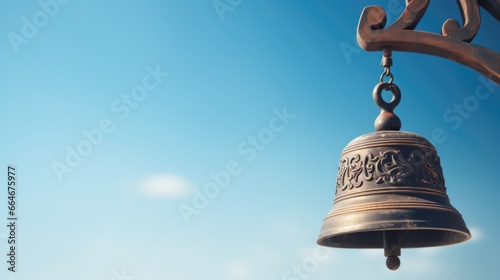 A chinese brass bell hanging from the side of a building. photo