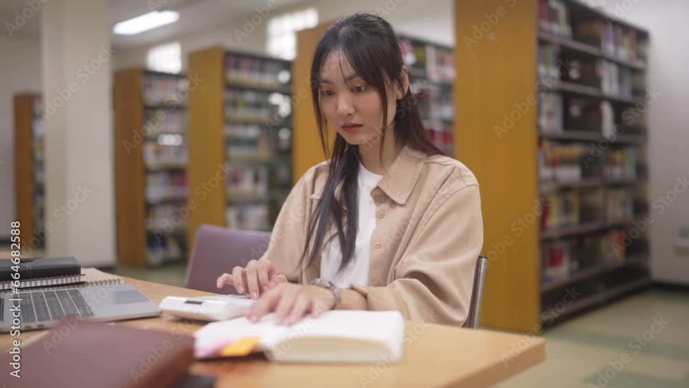 University Student sitting on desk Table for homework and study at library University Student sitting on desk Table for homework and study at library